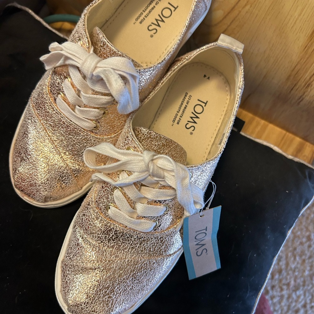 Toms metallic sneakers kids size 4 but fits ladies size 61/2